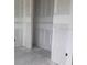 Unfinished hallway features concrete floors and walls leading to a bedroom at 706 Junonia Blvd, New Smyrna Beach, FL 32168
