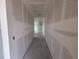 Unfinished hallway with freshly installed drywall ready for customization, showcasing a spacious layout at 706 Junonia Blvd, New Smyrna Beach, FL 32168