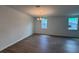 Spacious living room with hardwood floors, modern lighting, and bright, sunlit windows at 706 Junonia Blvd, New Smyrna Beach, FL 32168