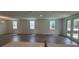Spacious living room with hardwood floors, modern lighting, and bright, sunlit windows at 706 Junonia Blvd, New Smyrna Beach, FL 32168