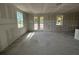Unfinished living room with natural light showcases an open floor plan, ready to be customized with drywall at 706 Junonia Blvd, New Smyrna Beach, FL 32168