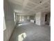 Spacious unfinished living room featuring drywall, large windows, and a door, ready for personalization at 706 Junonia Blvd, New Smyrna Beach, FL 32168