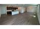 Open-concept living area featuring hardwood floors, connecting kitchen and living room spaces at 706 Junonia Blvd, New Smyrna Beach, FL 32168