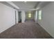 Spacious main bedroom featuring carpet floors, ample light, and en suite bathroom at 706 Junonia Blvd, New Smyrna Beach, FL 32168