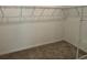 Walk-in closet with wire shelving and neutral carpet at 706 Junonia Blvd, New Smyrna Beach, FL 32168
