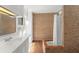Bathroom featuring a brick wall and a bathtub, providing a unique and rustic aesthetic at 7712 Hoosier Pl, Orlando, FL 32807