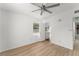 Bright bedroom with laminate flooring and a ceiling fan, featuring a small window to let in lots of light at 7712 Hoosier Pl, Orlando, FL 32807