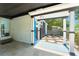 View of a modern entryway with block wall construction, dark trim accents, and blue door at 7712 Hoosier Pl, Orlando, FL 32807
