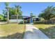 Stylish single-story home featuring a screened-in pool area, charming curb appeal, and lush landscaping at 7712 Hoosier Pl, Orlando, FL 32807