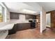 Open kitchen layout with ample dark cabinetry, black appliances, a skylight, and tiled floors at 7712 Hoosier Pl, Orlando, FL 32807