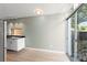 View of the kitchenette with stainless steel accents and a bright glass door leading to a lovely outdoor view at 7712 Hoosier Pl, Orlando, FL 32807
