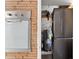 Laundry room with a modern washer and dryer set and a unique retro fold-down ironing board at 7712 Hoosier Pl, Orlando, FL 32807