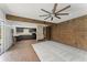 Large living room showcases a view to the kitchen, unique wall features, and exterior views from the sliding door at 7712 Hoosier Pl, Orlando, FL 32807