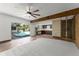 Expansive living room with pool view through sliding doors, with access to the kitchen and unique room features at 7712 Hoosier Pl, Orlando, FL 32807