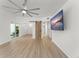 Spacious living room featuring wood floors, barn door entry, and slider access to the pool at 7712 Hoosier Pl, Orlando, FL 32807