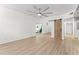 Spacious living room featuring wood floors, barn door entry, and slider access to the backyard pool at 7712 Hoosier Pl, Orlando, FL 32807