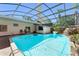 This in-ground pool with a waterfall and bar area is perfect for outdoor entertaining at 7712 Hoosier Pl, Orlando, FL 32807