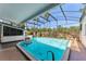 This is an in-ground pool with a waterfall and a bar area at 7712 Hoosier Pl, Orlando, FL 32807