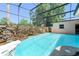 Enjoy this sparkling screened in-ground pool with a stone waterfall and ample space at 7712 Hoosier Pl, Orlando, FL 32807