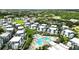 Drone view of community showcasing pool, surrounding trees, and residential buildings at 7770 Sandy Ridge Dr # 234, Reunion, FL 34747