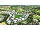 Aerial view of a community with golf course, landscaped grounds, and modern buildings at 7770 Sandy Ridge Dr # 234, Reunion, FL 34747