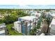 Stunning aerial view of modern townhouses with private balconies and lush landscaping in a well-planned community at 7770 Sandy Ridge Dr # 234, Reunion, FL 34747