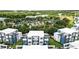 Community aerial view of modern townhouses near resort-style pool and clubhouse, surrounded by lush greenery at 7770 Sandy Ridge Dr # 234, Reunion, FL 34747