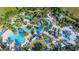 A stunning aerial view captures the resort's pools, lazy river, lush landscaping, and sun loungers at 7770 Sandy Ridge Dr # 234, Reunion, FL 34747