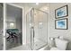 Modern bathroom with a glass shower, toilet, and view into the game room at 7770 Sandy Ridge Dr # 234, Reunion, FL 34747