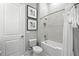 Bright bathroom with a bathtub, shower, tiled wall, and modern fixtures, exuding a clean, contemporary style at 7770 Sandy Ridge Dr # 234, Reunion, FL 34747