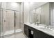 Modern bathroom featuring double sinks, a large mirror, and glass shower with floor to ceiling tiles at 7770 Sandy Ridge Dr # 234, Reunion, FL 34747