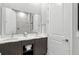 Modern bathroom featuring double vanity, a large mirror, stylish lighting, and a walk-in shower at 7770 Sandy Ridge Dr # 234, Reunion, FL 34747