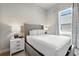 Comfortable bedroom with soft lighting, neutral tones, and a view to the outside at 7770 Sandy Ridge Dr # 234, Reunion, FL 34747