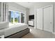 Bright bedroom featuring a large window with vibrant views, soft decor, and ample closet space at 7770 Sandy Ridge Dr # 234, Reunion, FL 34747