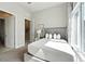 Well-lit bedroom featuring a plush bed, stylish decor, and an open doorway, offering a cozy retreat at 7770 Sandy Ridge Dr # 234, Reunion, FL 34747