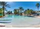 Spacious community pool area with lounge seating, umbrellas, and well-maintained landscaping for relaxation at 7770 Sandy Ridge Dr # 234, Reunion, FL 34747