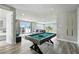 Open game room with a pool table and connected living room with an outdoor view at 7770 Sandy Ridge Dr # 234, Reunion, FL 34747