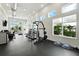 Bright gym with modern equipment, rubber flooring, and large windows offering scenic views for a healthy lifestyle at 7770 Sandy Ridge Dr # 234, Reunion, FL 34747