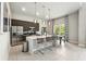 Bright, contemporary kitchen with stainless steel appliances, island seating, and tile flooring at 7770 Sandy Ridge Dr # 234, Reunion, FL 34747