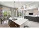 Open concept kitchen features quartz counters, modern appliances, and an eat-in island with views of the living space at 7770 Sandy Ridge Dr # 234, Reunion, FL 34747
