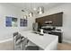 Bright kitchen featuring stainless steel appliances, stylish pendant lighting, and a spacious quartz countertop island with seating at 7770 Sandy Ridge Dr # 234, Reunion, FL 34747