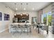 Modern kitchen with stainless steel appliances, a spacious island with seating, and an adjacent dining area at 7770 Sandy Ridge Dr # 234, Reunion, FL 34747