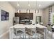 Modern kitchen with stainless steel appliances, a large island, and pendant lighting at 7770 Sandy Ridge Dr # 234, Reunion, FL 34747