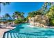 Lazy river features a tranquil setting with lush landscaping and rock features for a serene experience at 7770 Sandy Ridge Dr # 234, Reunion, FL 34747