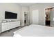 Serene bedroom featuring a large dresser, TV, and an open entryway to other parts of the property at 7770 Sandy Ridge Dr # 234, Reunion, FL 34747