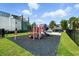 Bright playground with colorful play structure, soft rubber flooring, and lush green surroundings for outdoor fun at 7770 Sandy Ridge Dr # 234, Reunion, FL 34747