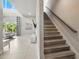 Bright, modern staircase leading to the upper level with wood handrail and tile floors at 7770 Sandy Ridge Dr # 234, Reunion, FL 34747