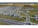 Aerial view of a new home community, with highway access, green space, and community amenities nearby at 7779 Trapani Loop, Clermont, FL 34714