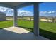 Covered lanai showcasing an expansive backyard with beautiful green grass and a scenic view at 7779 Trapani Loop, Clermont, FL 34714