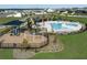 A lovely community pool area with a splash pad, playground, and covered seating at 7779 Trapani Loop, Clermont, FL 34714